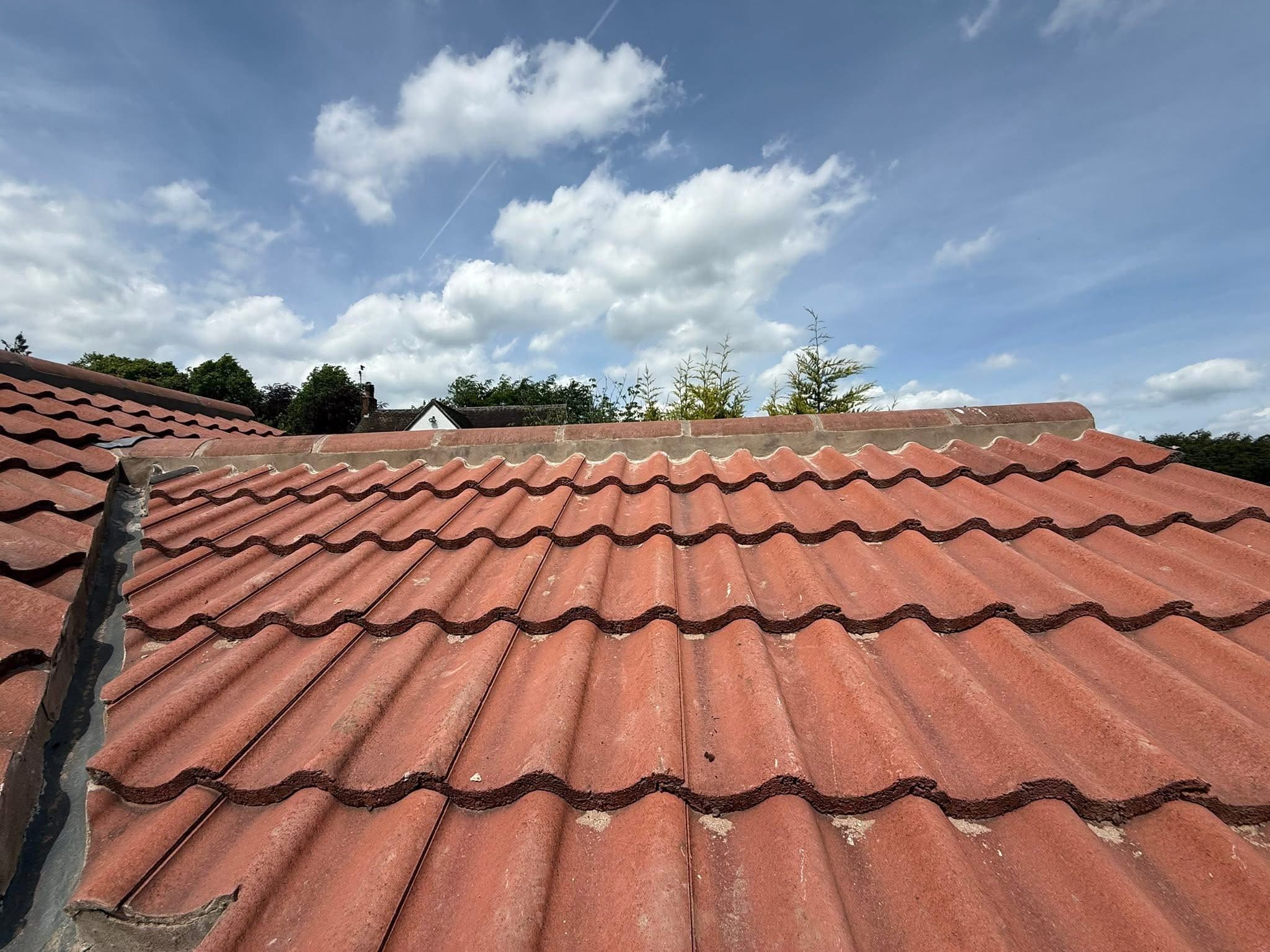 Ridge tiles removed and re-bedded