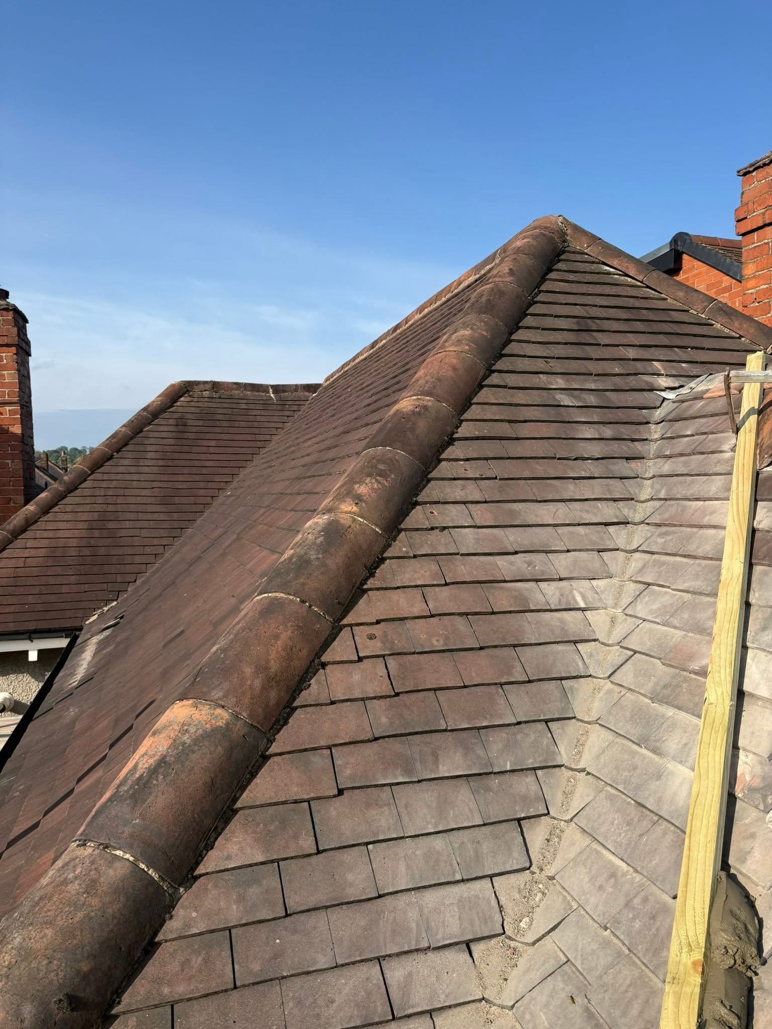 Ridge tiles stripped and re-bedded, before
